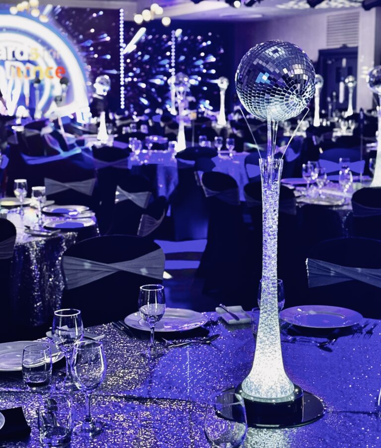 Lily vase with silver mirror balls - on vase uplight (cool white light) Also displaying our silver sequin table overlays and black covers and silver bands