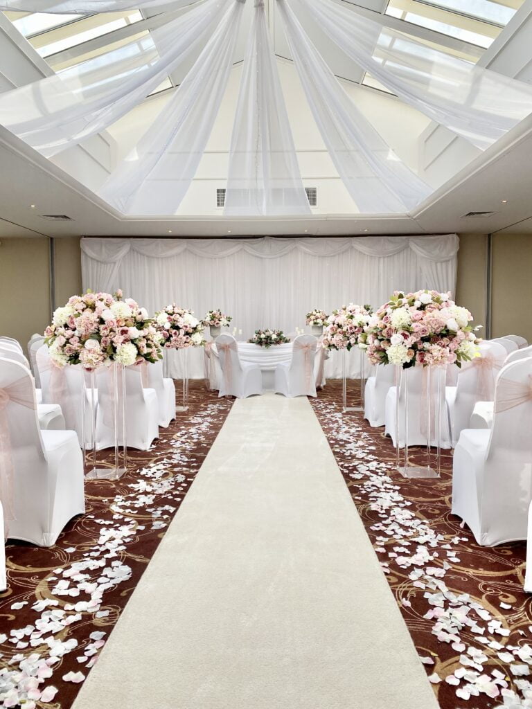 Starlight backdrop, ceiling drapes, aisle runner, petals and Natalia Centrepieces